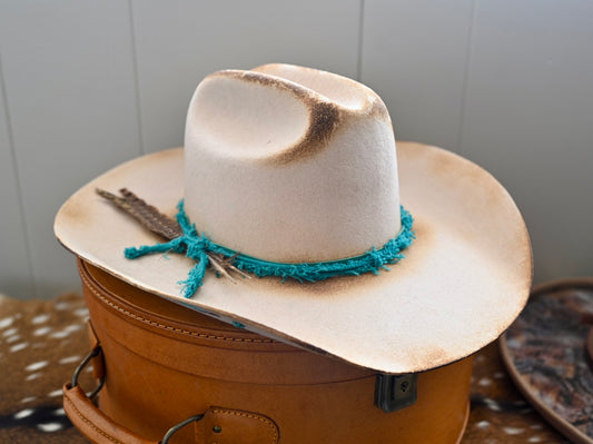 Ezra ivory felt cowboy hat with painted branding and Kingman turquoise accents.